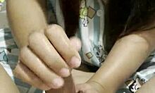 Young Asian beauty gives great handjob to her lover