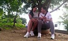 Exhibitionist lesbian couple licks big natural tits in public park daylight.