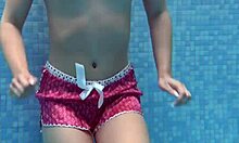 Cute shy Czech teen Lady Dee swimming in pool.