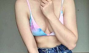 Teen in skirt and swimsuit bra shows off