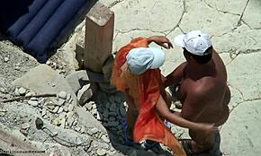 Bronzed Beauty Bends Over for Doggystyle on Beach, Caught on Hidden Cam!