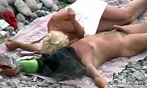blondie secretly strokes her boyfriend’s rod on a sunny beach