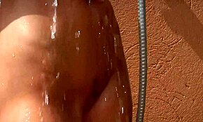 Wet teen beauty showers outdoors, posing and showing off her perfect body.