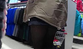 a hidden camera in a fitting room spies on a girl with a gorgeous ass and beautiful legs in pantyhose then a voyeur peeks under her skirt in a public store amateur foot fetish