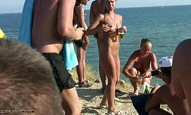 Two rowdy Russian nudists chugging beer on the beach, fully bare. Hidden cam caught it all.