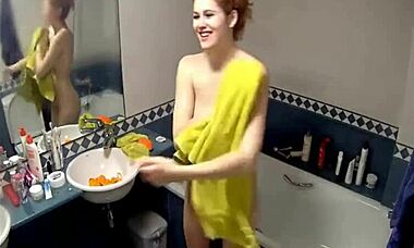 curly-haired redhead teen reveals amateur body on hidden cam. her perfect shape stuns in softcore.