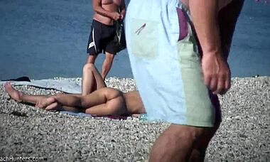 busty babe begs her man to adjust her tiny bikini on the beach, so tempting!