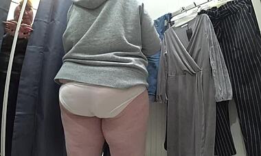 a plump russian milf's juicy ass in white panties. big tits in a bra caught on hidden camera in public dressing room.